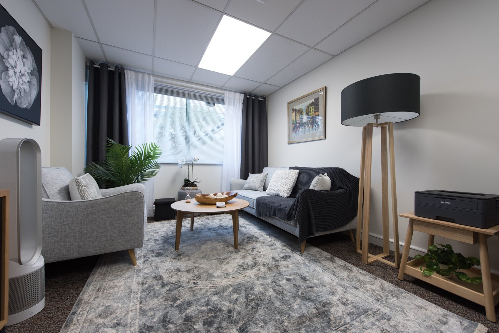 Consultation room with an armchair, sofa and natural light