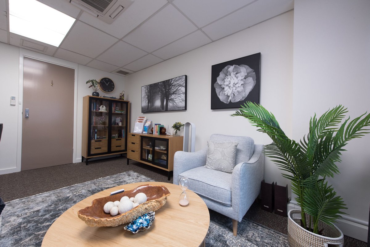 Armchair, coffee table and greenery in a Perth Clinic consultation room